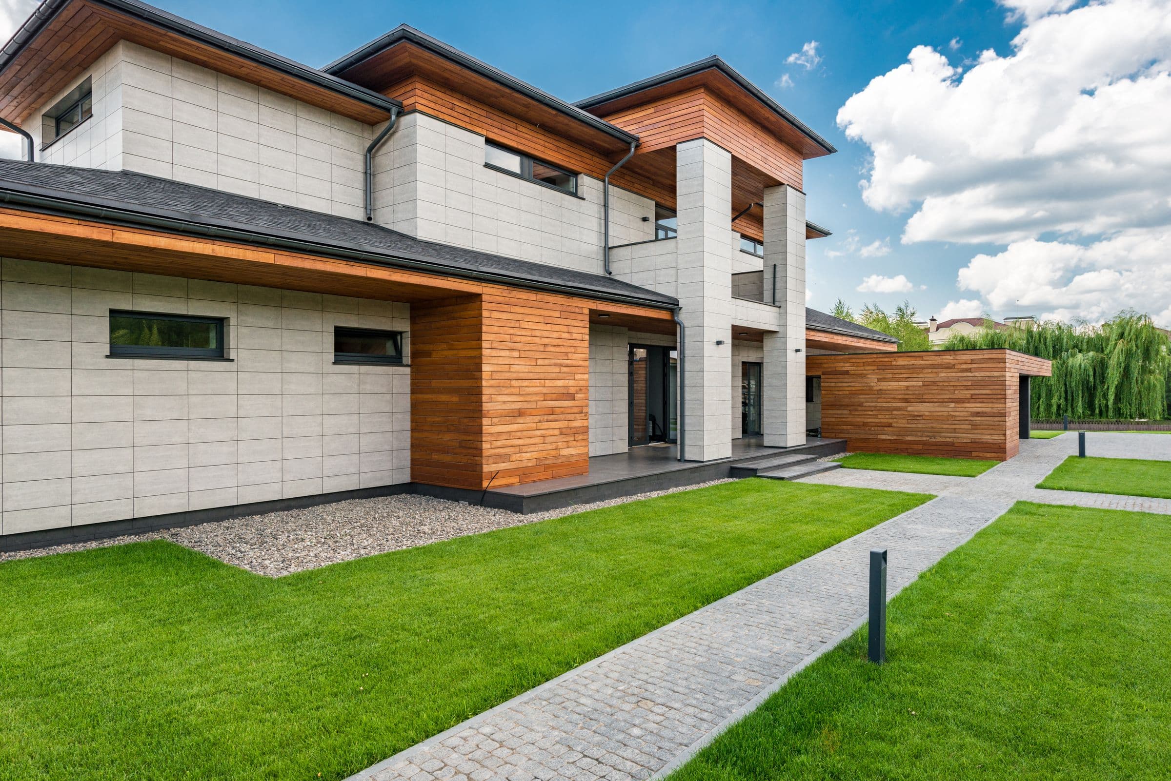 Modernes Wohnhaus mit Rasenfläche und Gartenweg